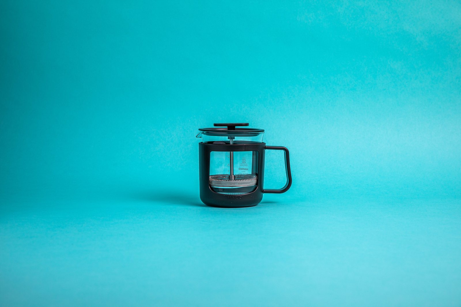 Hario Cafe Press U 300 ml, a small heatproof glass French press with a black plastic holder and stainless plunger