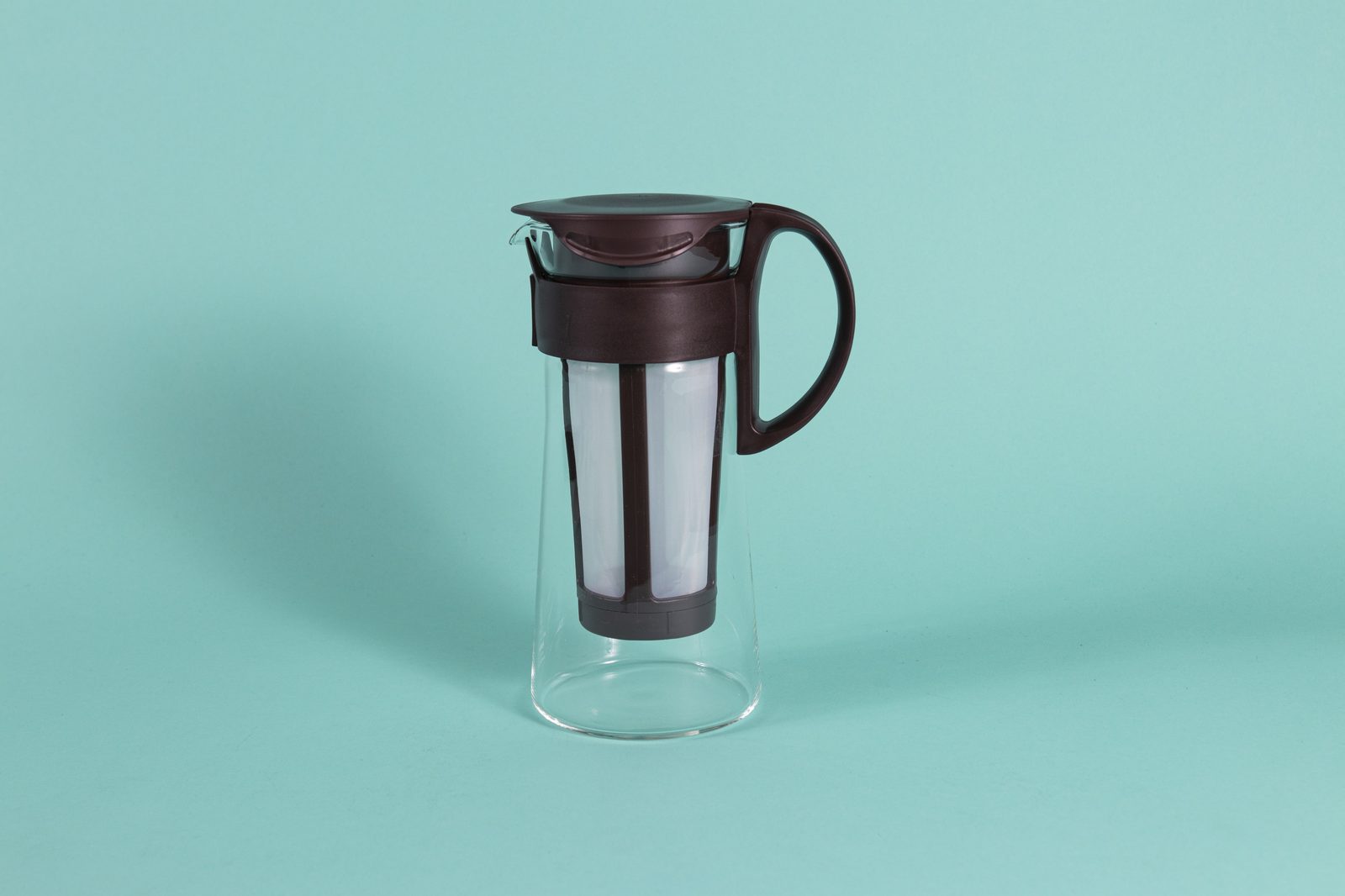 Hario Mizudashi cold brew coffee pot in brown, a slim glass carafe with a mesh filter in the lid