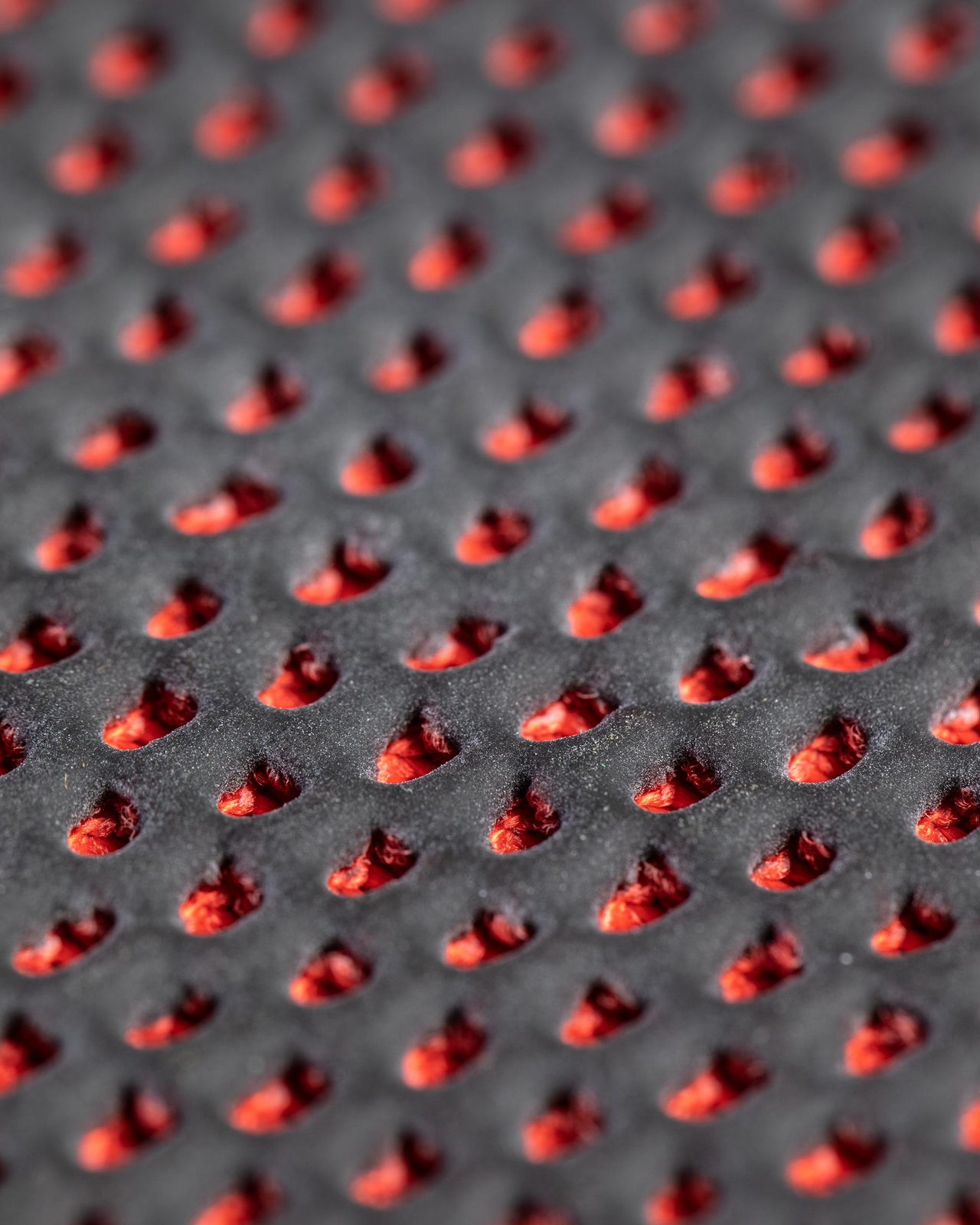 Close view of the red synthetic clay face of a clay mitt