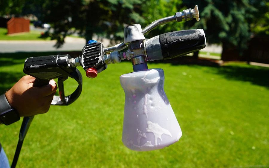 The MTM Hydro PF22.2 foam cannon fitted to a pressure washer gun and being used outdoors